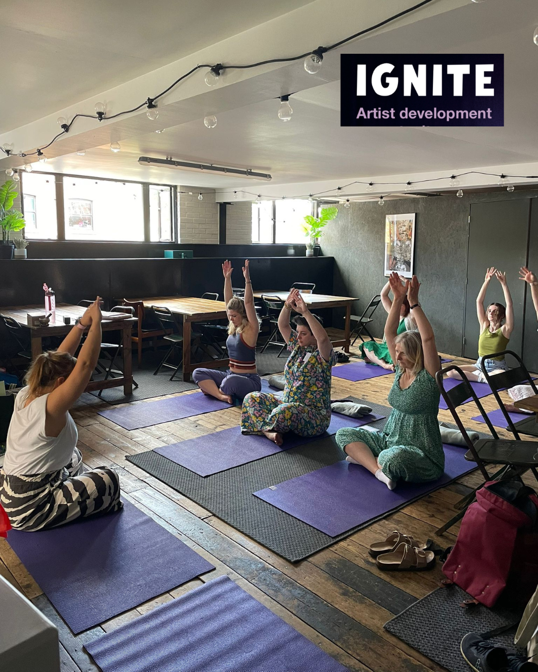 Ignite Artists takinhg part in Workshop on yoga mats in stretch positions