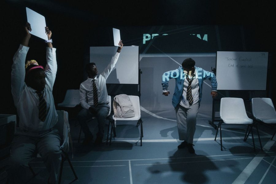 A performer with the word problem projected onto their body.
