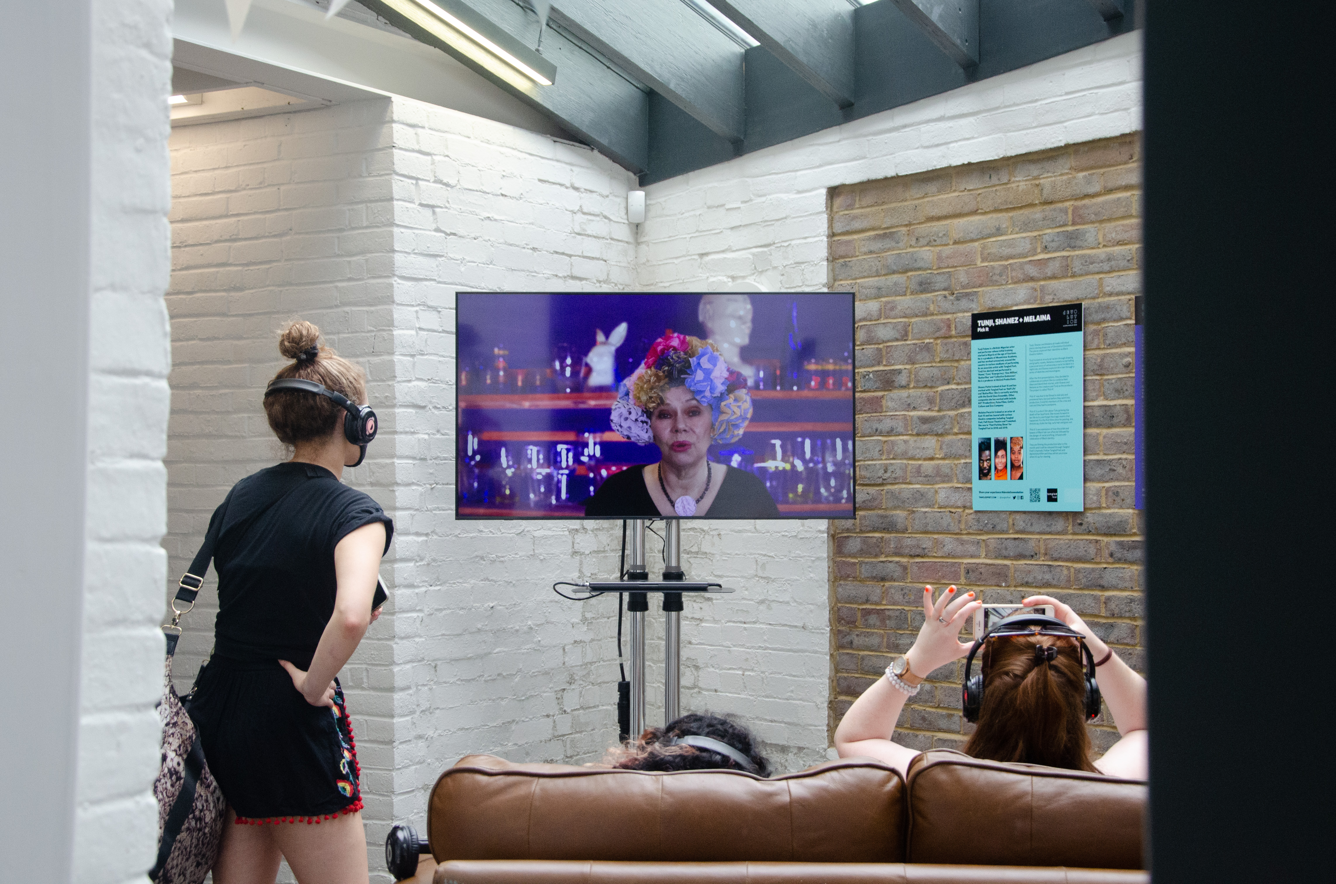 Fiona on screen with audience in Hat Works, Luton